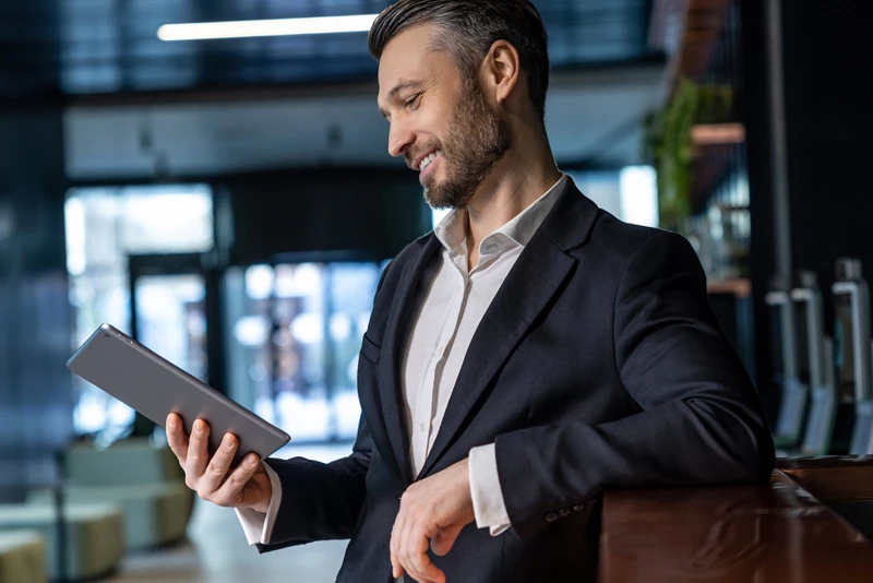 Image ofa businessman looking at his tablet in an office