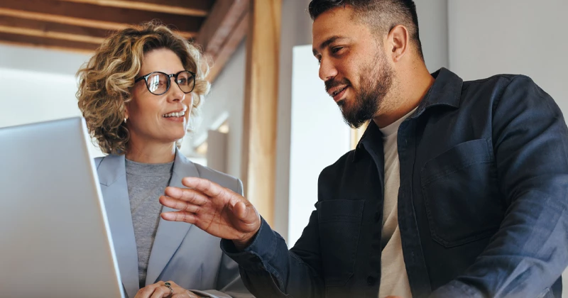 Image of a client meeting with a commercial banker holding a laptop