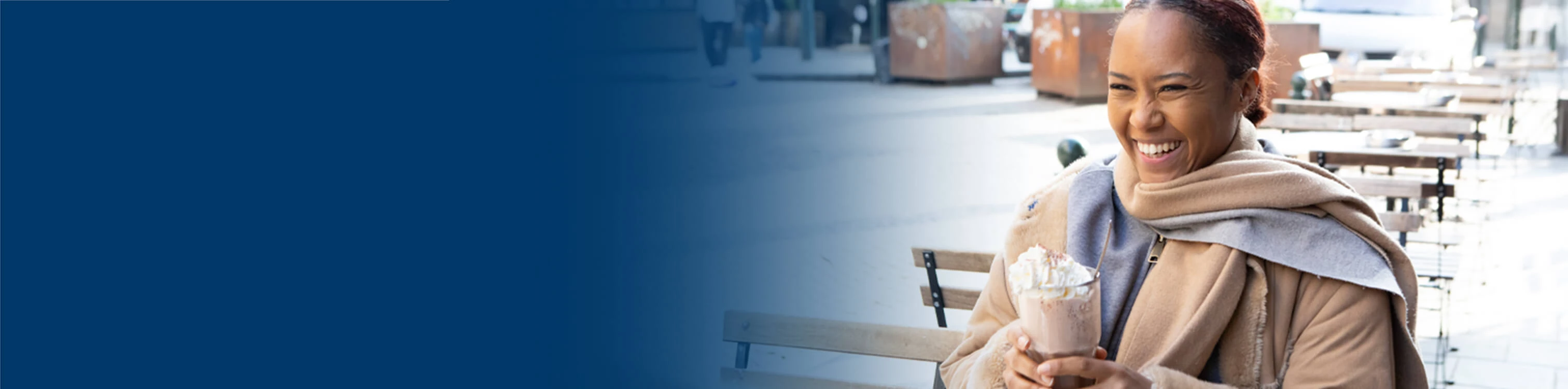 A woman out having a cup of iced coffee with a friend