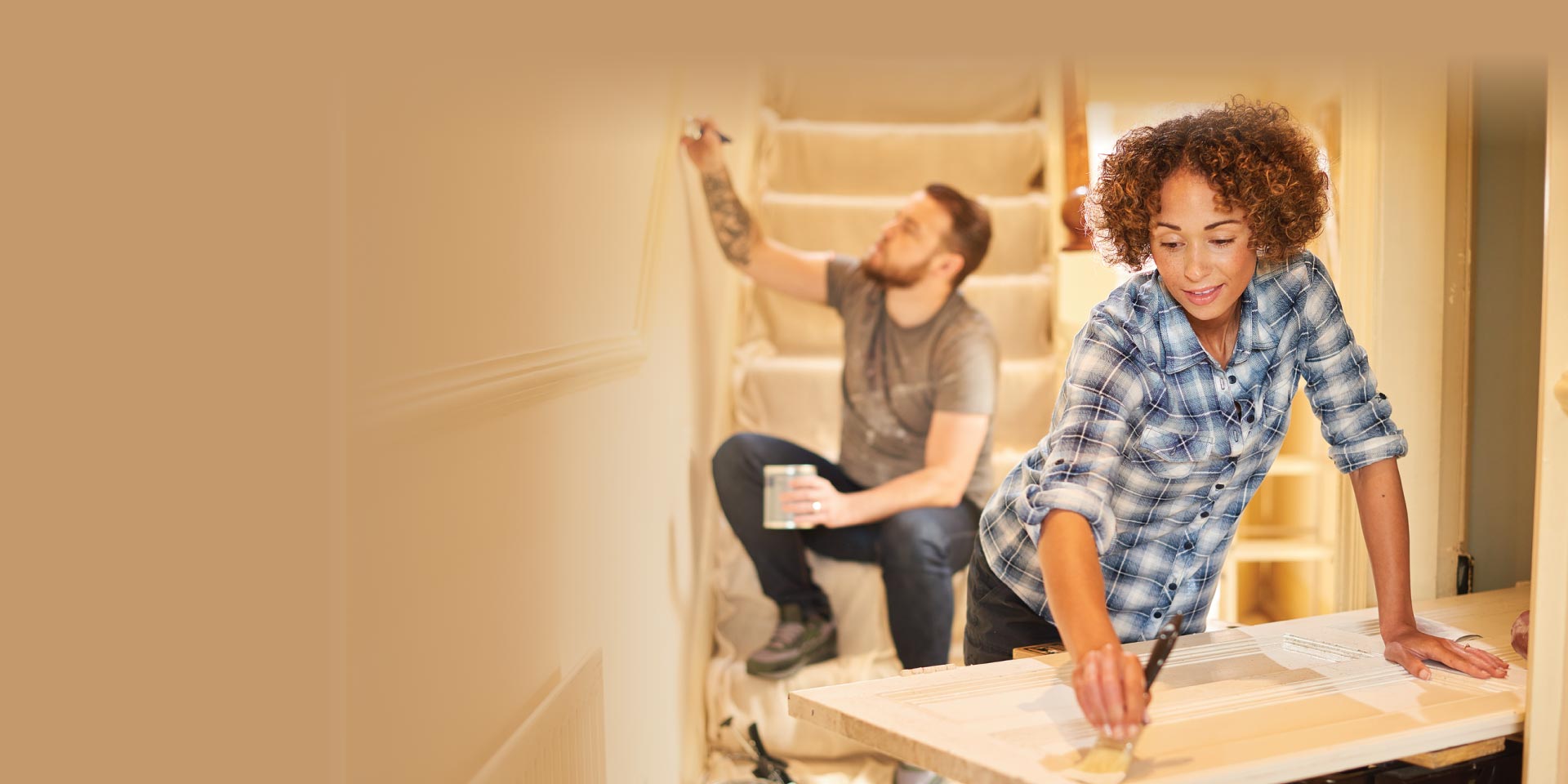 A man and woman working on updating their home