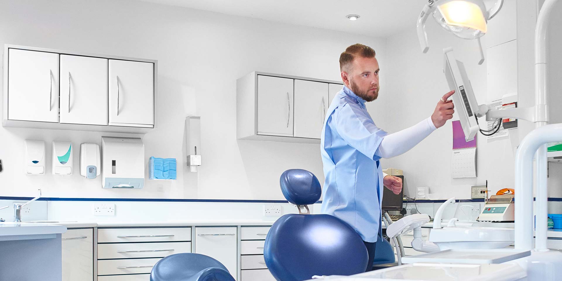 A dental professional prepares his office for patients after receiving professional services banking and financing