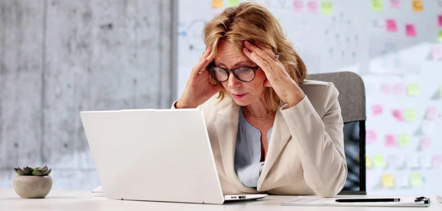 A woman looking up fraud resources on her laptop