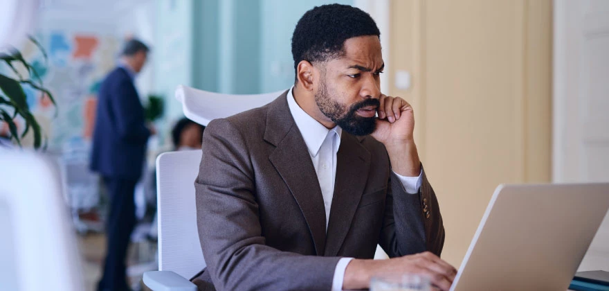 A man reading an article about fraud prevention