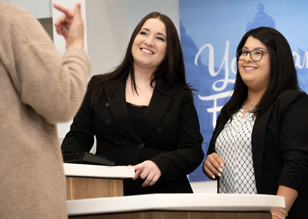 Two associates meeting with a client