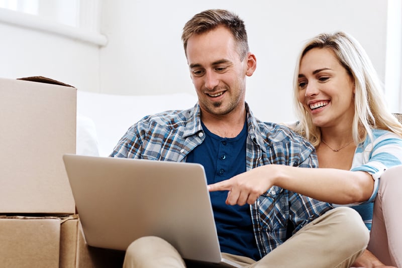 A couple making a loan payment online