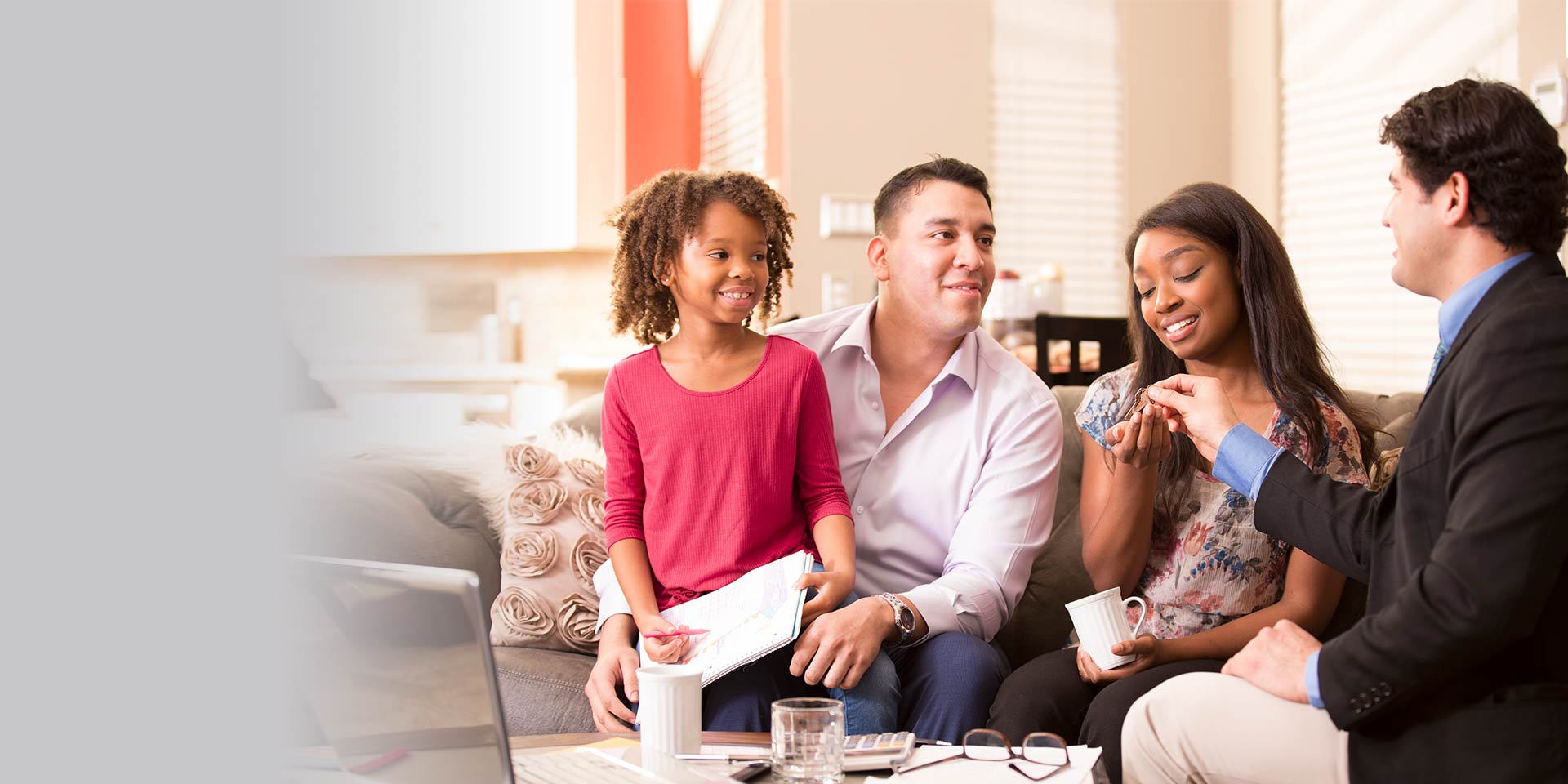 A young family who are wealth management and fiduciary service clients receive keys to a new home