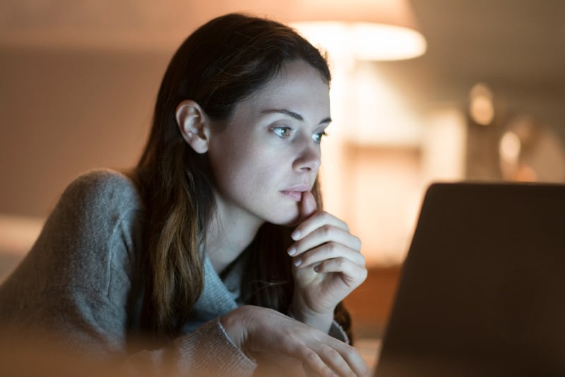 A woman looking at her laptop