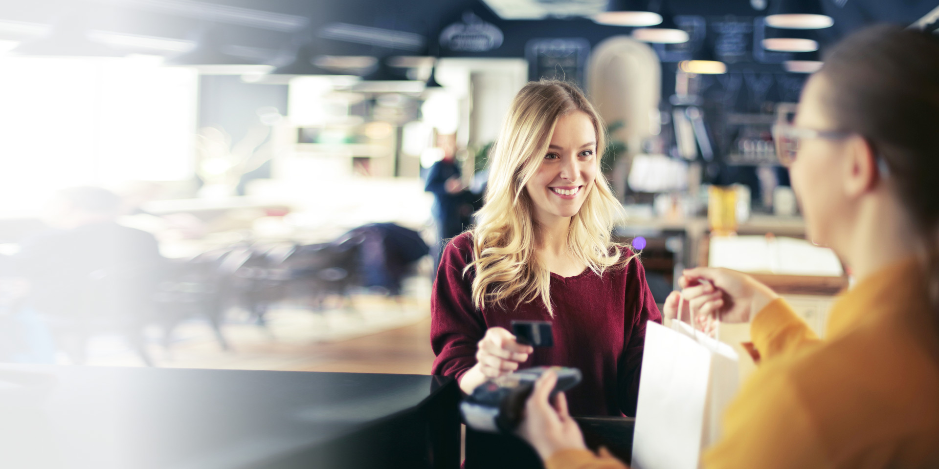 A woman paying with her credit card at the store