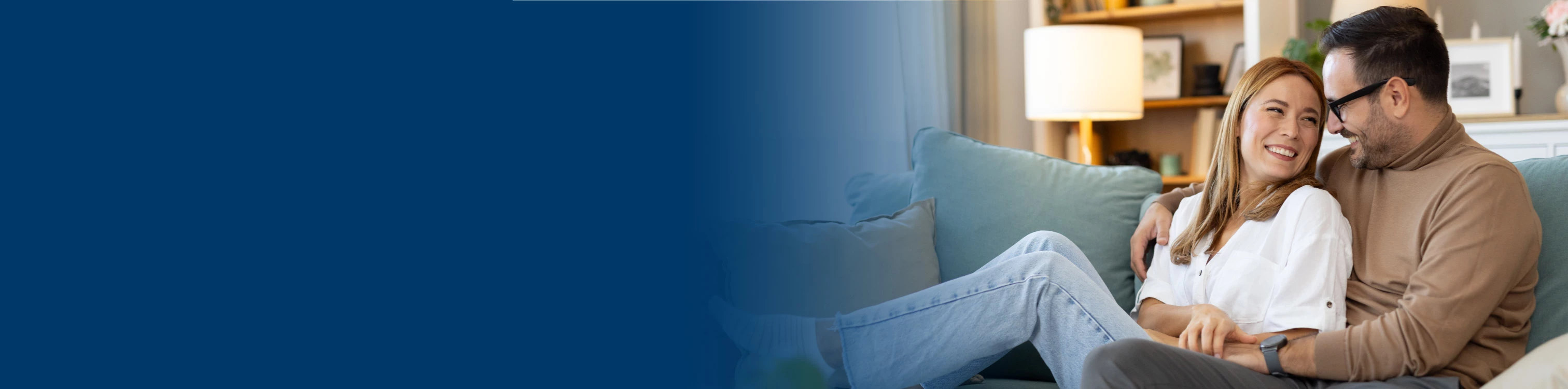 A couple sitting together on the couch