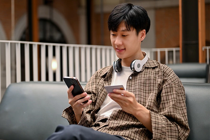 A man signing up for card controls on his phone