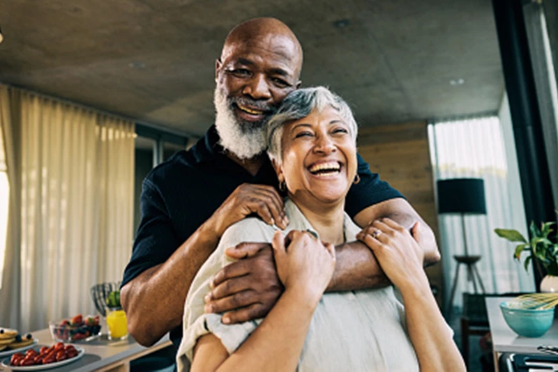 A couple laughing in their living room
