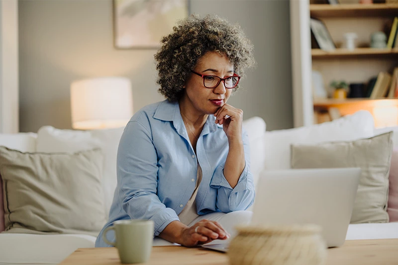 A woman researching digital banking on her laptop