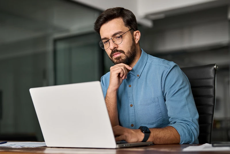 A man looking at his laptop