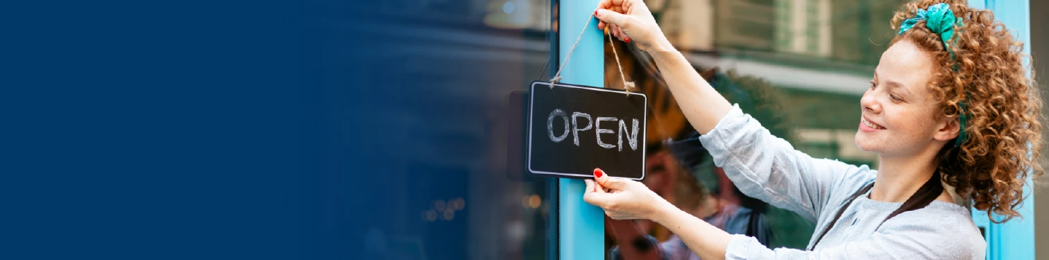 A shop owner opening up her store
