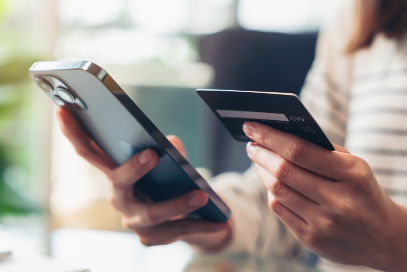 A woman paying by credit card