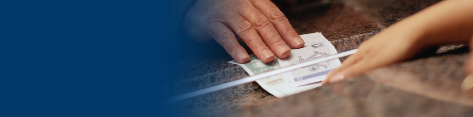 Handing money under a teller line glass