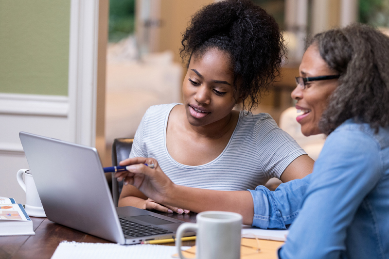 A mom and daughter working on her daughter's financials