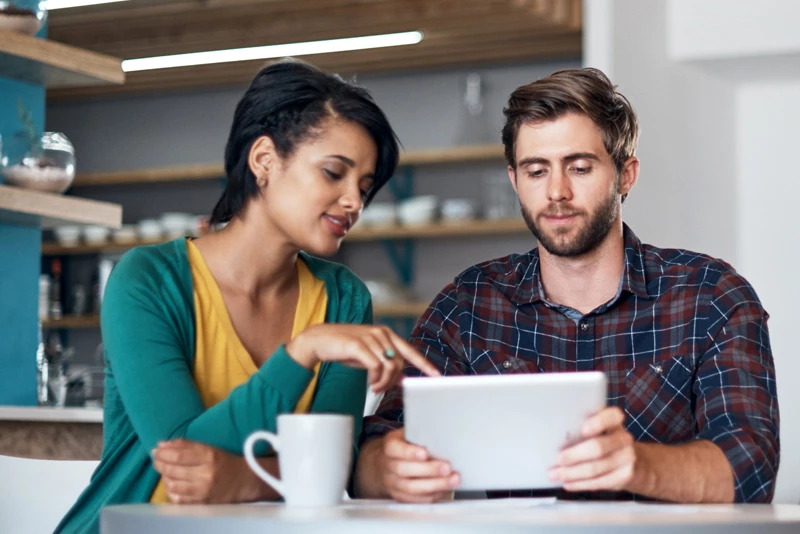 Two friends looking at their financials