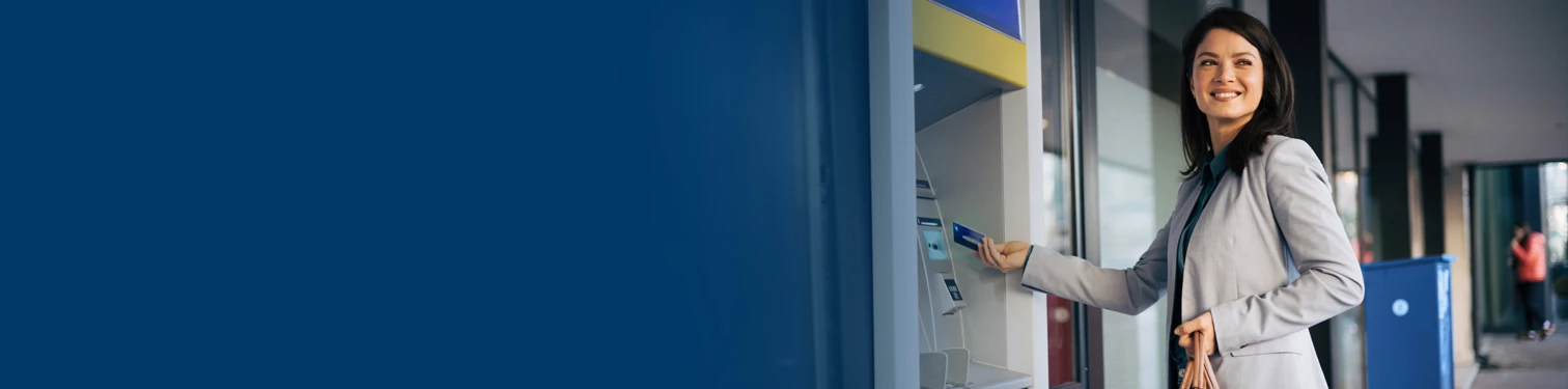 A woman depositing money at her ATM