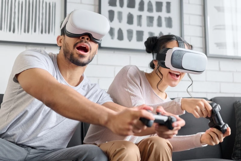 Image of a couple on the couch playing a VR videogame