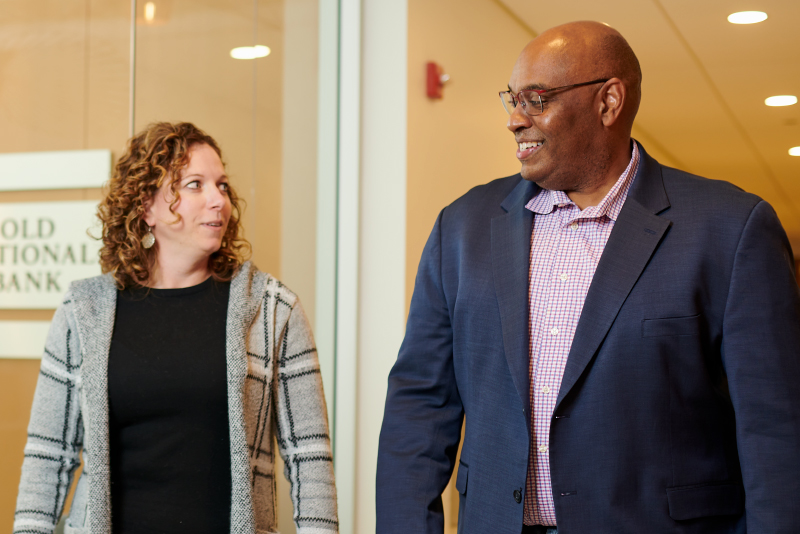 Two colleagues talking in the hallway