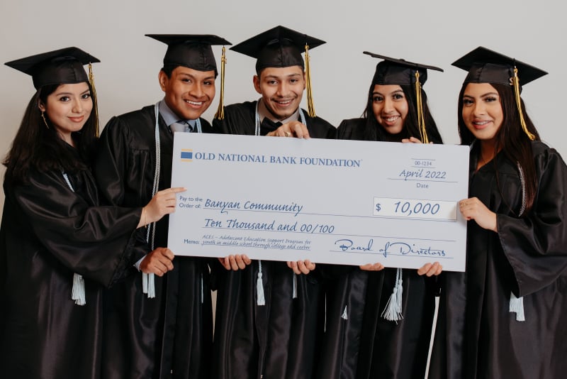 Graduates holding a check from Old National Bank
