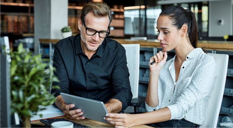 Two coworkers meeting to discuss their client's needs