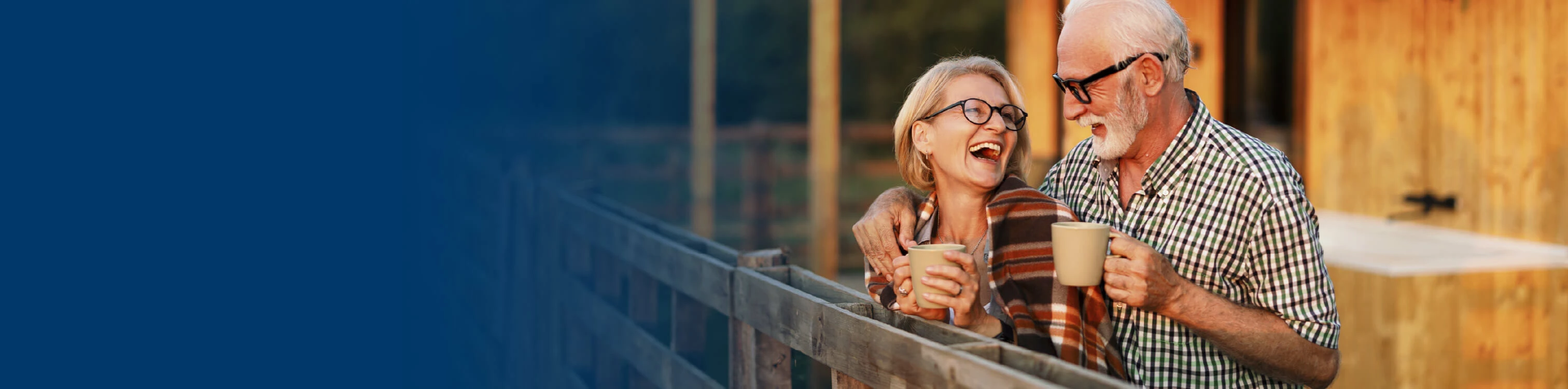 An older couple out on a balcony enjoying the weather
