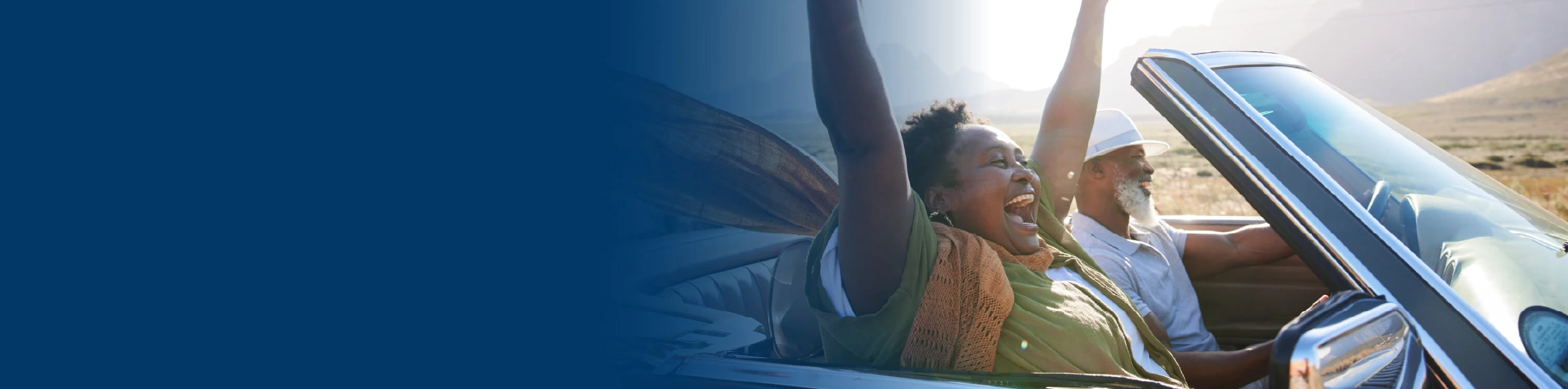 Couple riding in a convertible with the top down