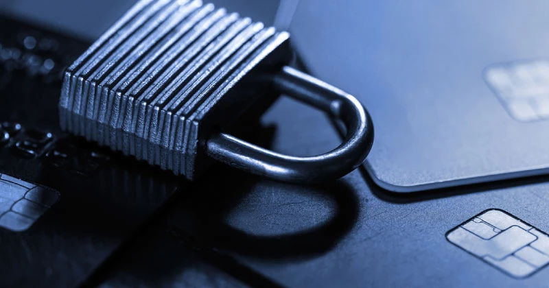 A close-up image of a padlock on top of credit cards