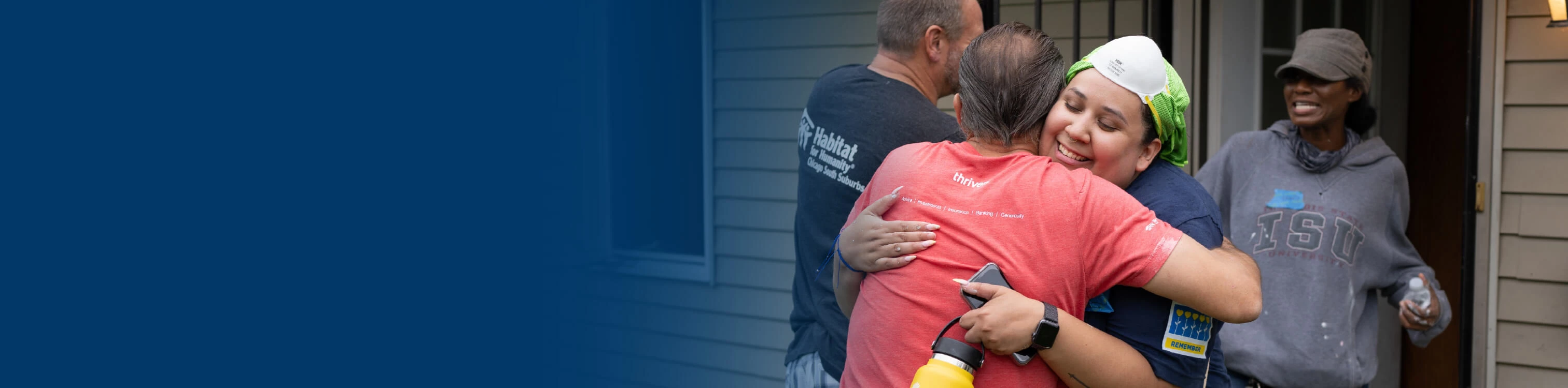 An Old National Bank volunteering hugging a man while out helping the community