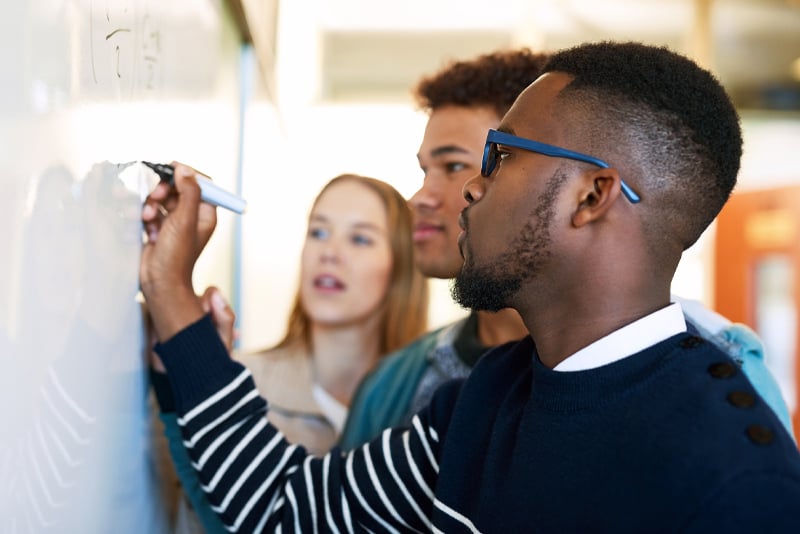 A classroom project being documented on a white board