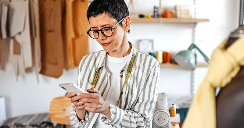 A woman using her phone to make a payment