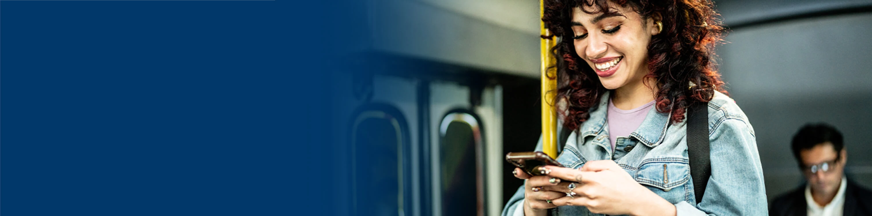 A woman on public transit looking at her phone