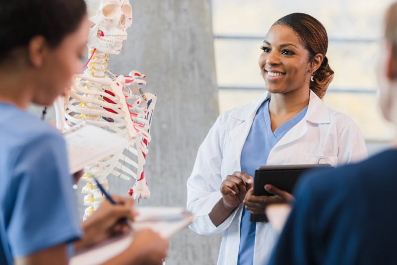 A physician talking to her coworkers