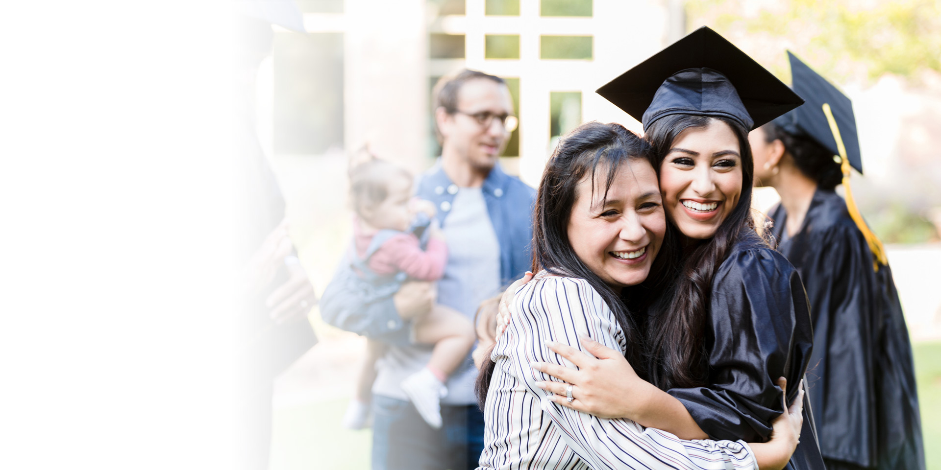 A mom hugging her daughter at her college graduation