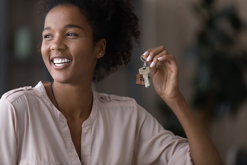 A woman getting keys to her first home