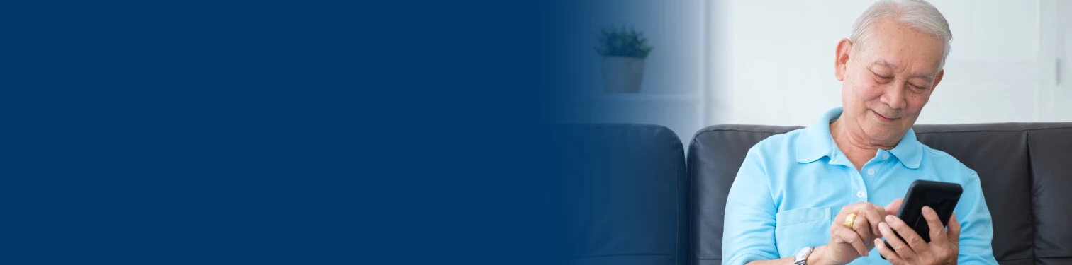 A man using his mobile device for touchtone banking