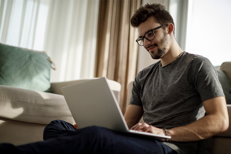 A man looking on his laptop for financial advice
