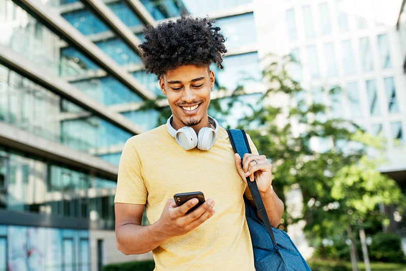 A man looking at his banking account on his mobile banking app