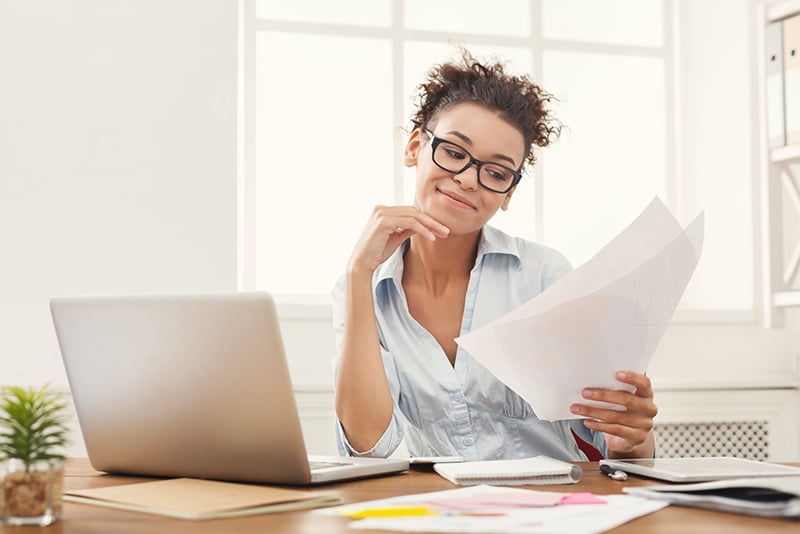 A woman looking at her printed banking statements