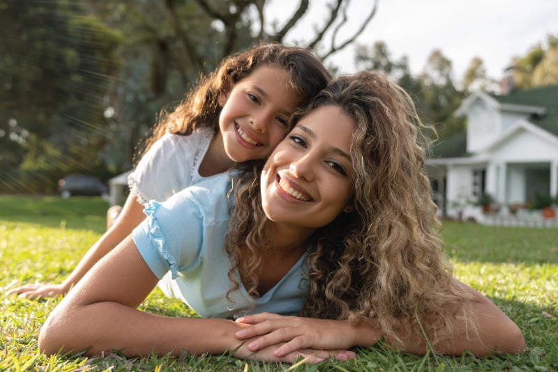 A mom and daughter outside playing