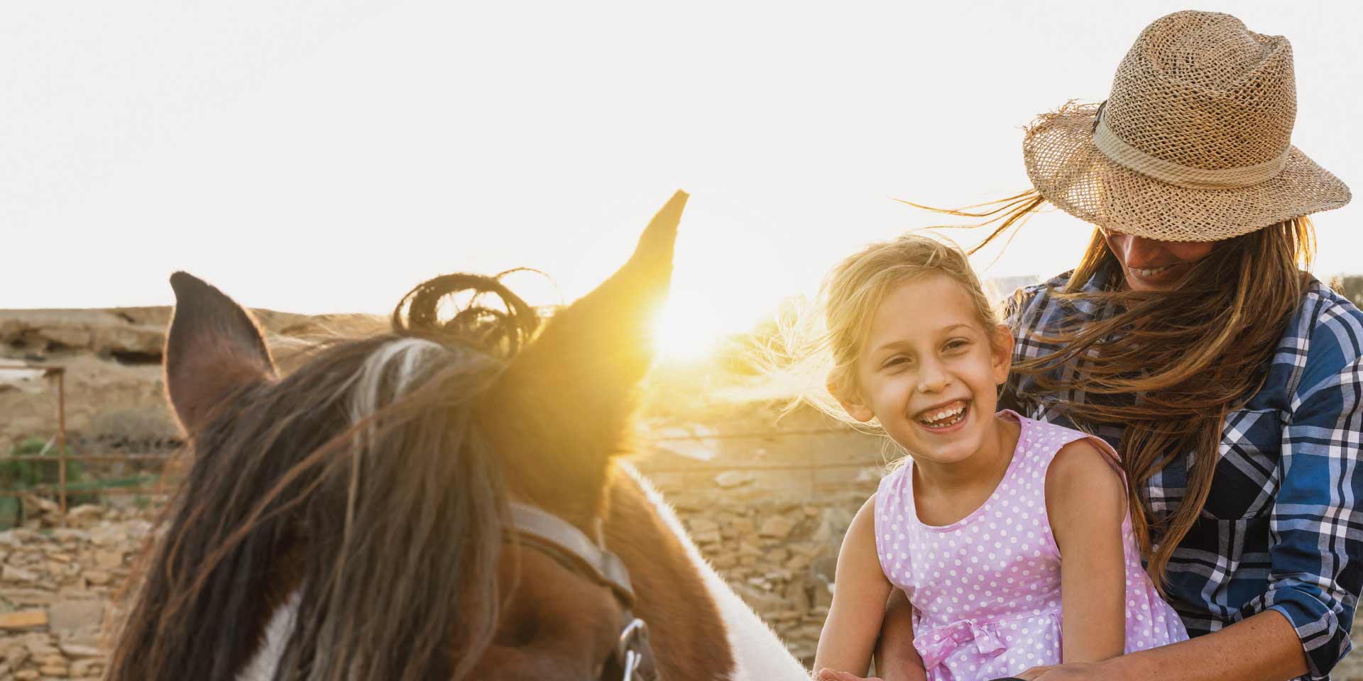 A mom and daughter out taking a ride on their horse