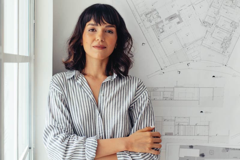 An accountant in her office next to her whiteboard