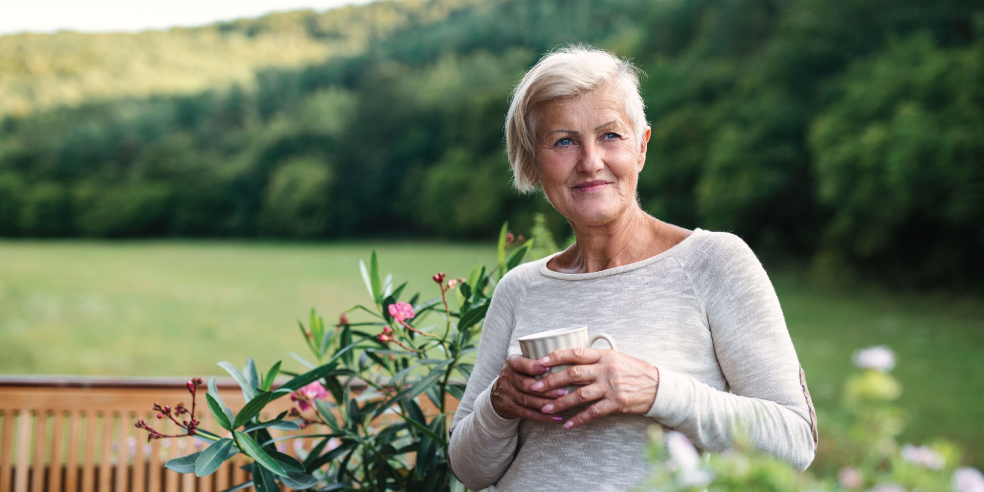 A woman drinking coffee on her patio