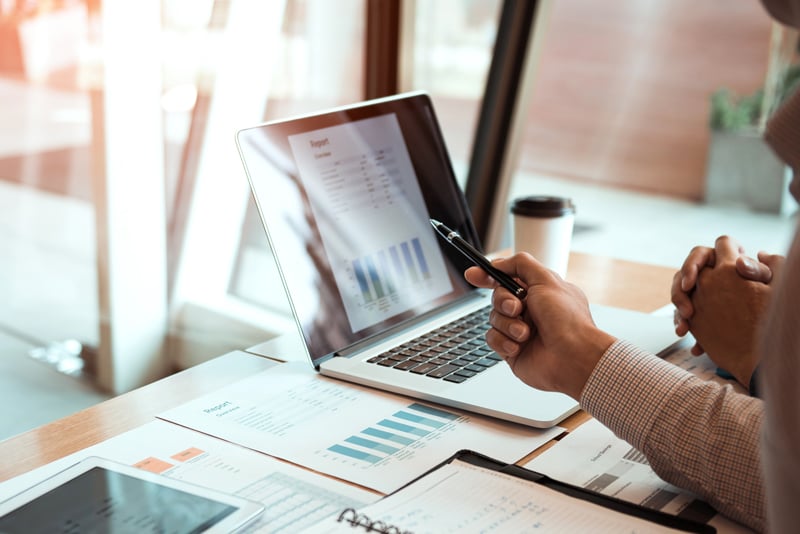 A client working on their financials at their laptop