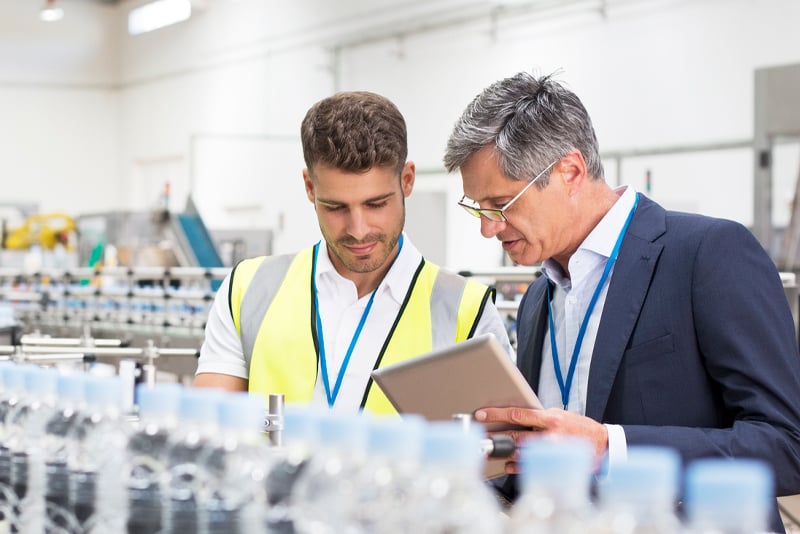 A worker and his box looking at some manufacturing charts