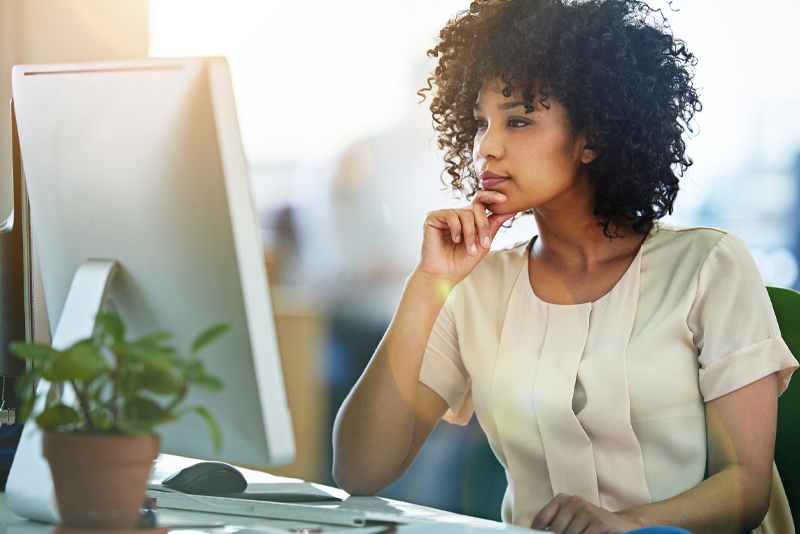 A woman looking at her emails on her desktop