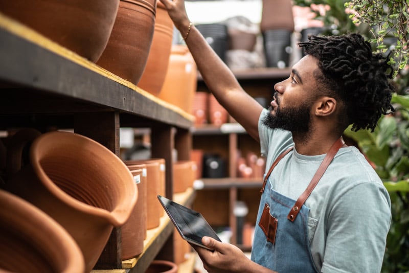 A small business owner looking at his inventory