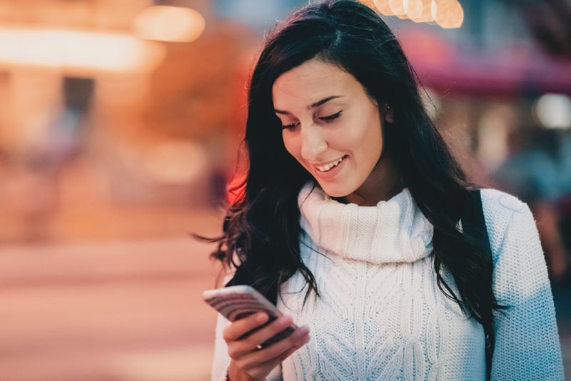 A consumer looking at her mobile device